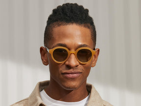Model is wearing The GREPS SUN in Honey/Tortoise in size 47 with Forest Wood Tinted Lenses