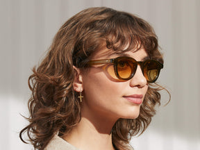 Model is wearing The DAHVEN SUN in Olive Brown in size 44 with Chestnut Fade Tinted Lenses