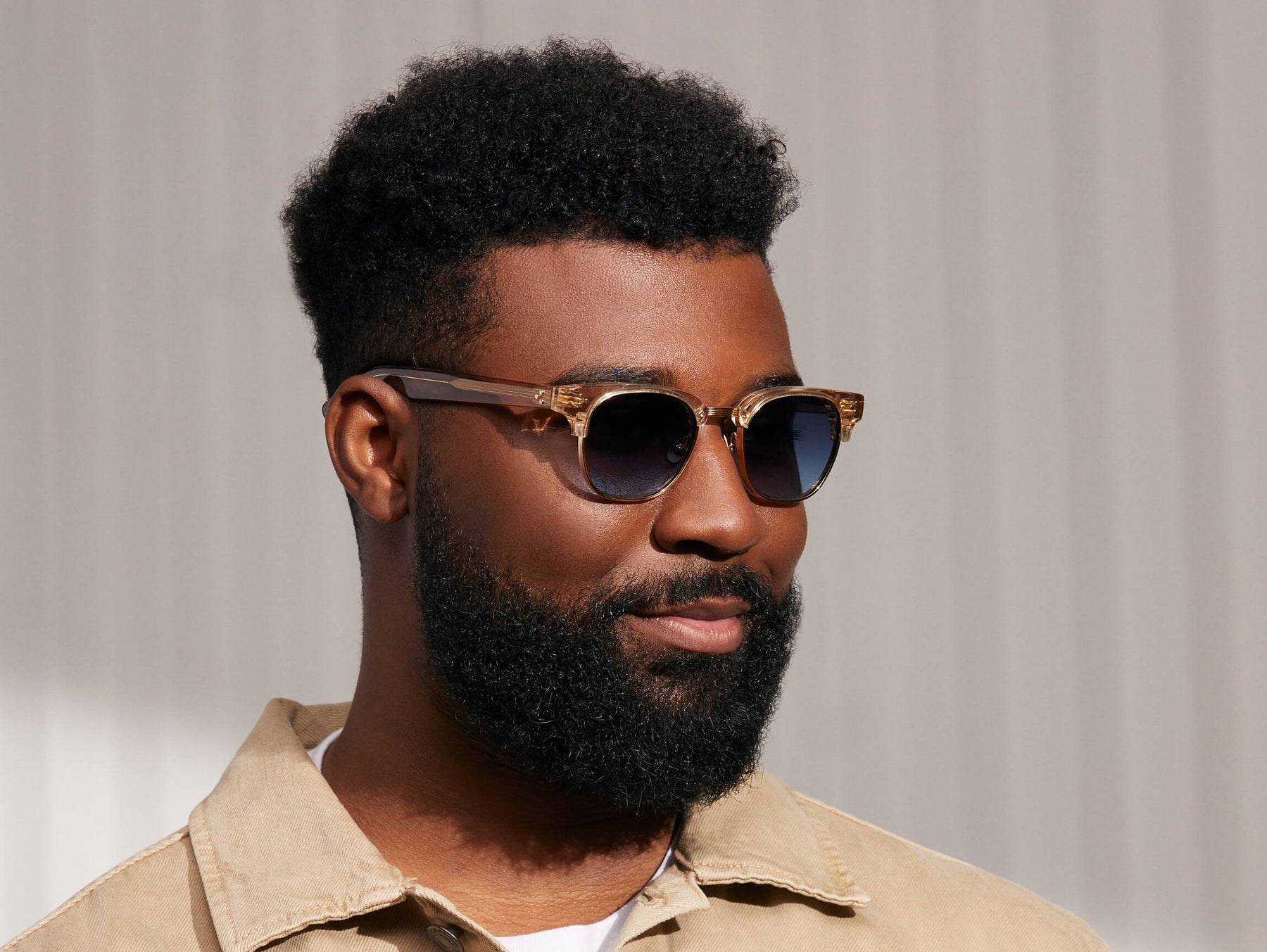 Model is wearing The TINIF SUN in Cinnamon/Gold in size 48 with Denim Blue Tinted Lenses