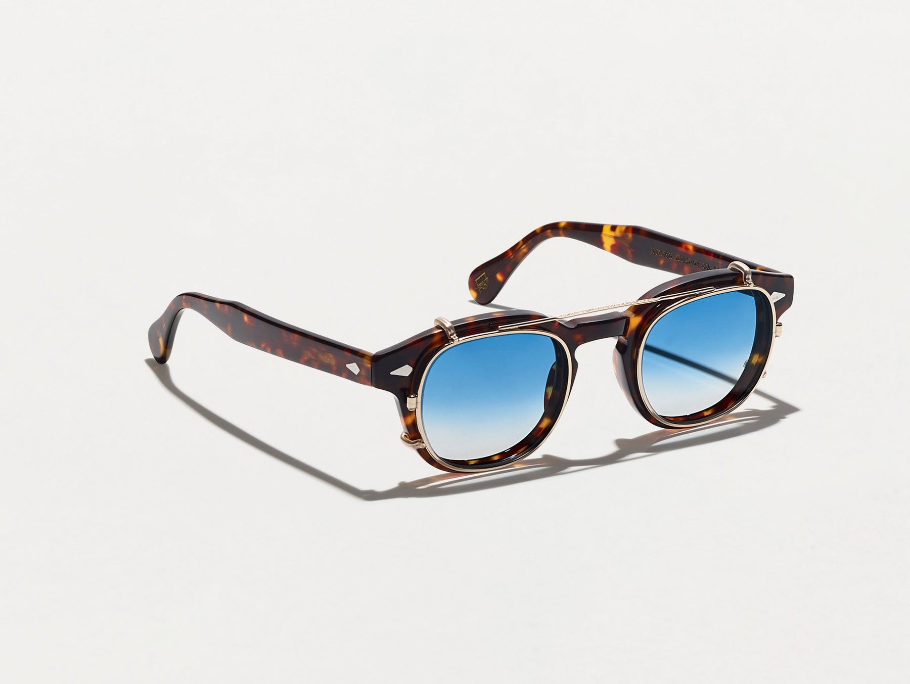 The CLIPTOSH in Gold with Broadway Blue Fade Tinted Lenses