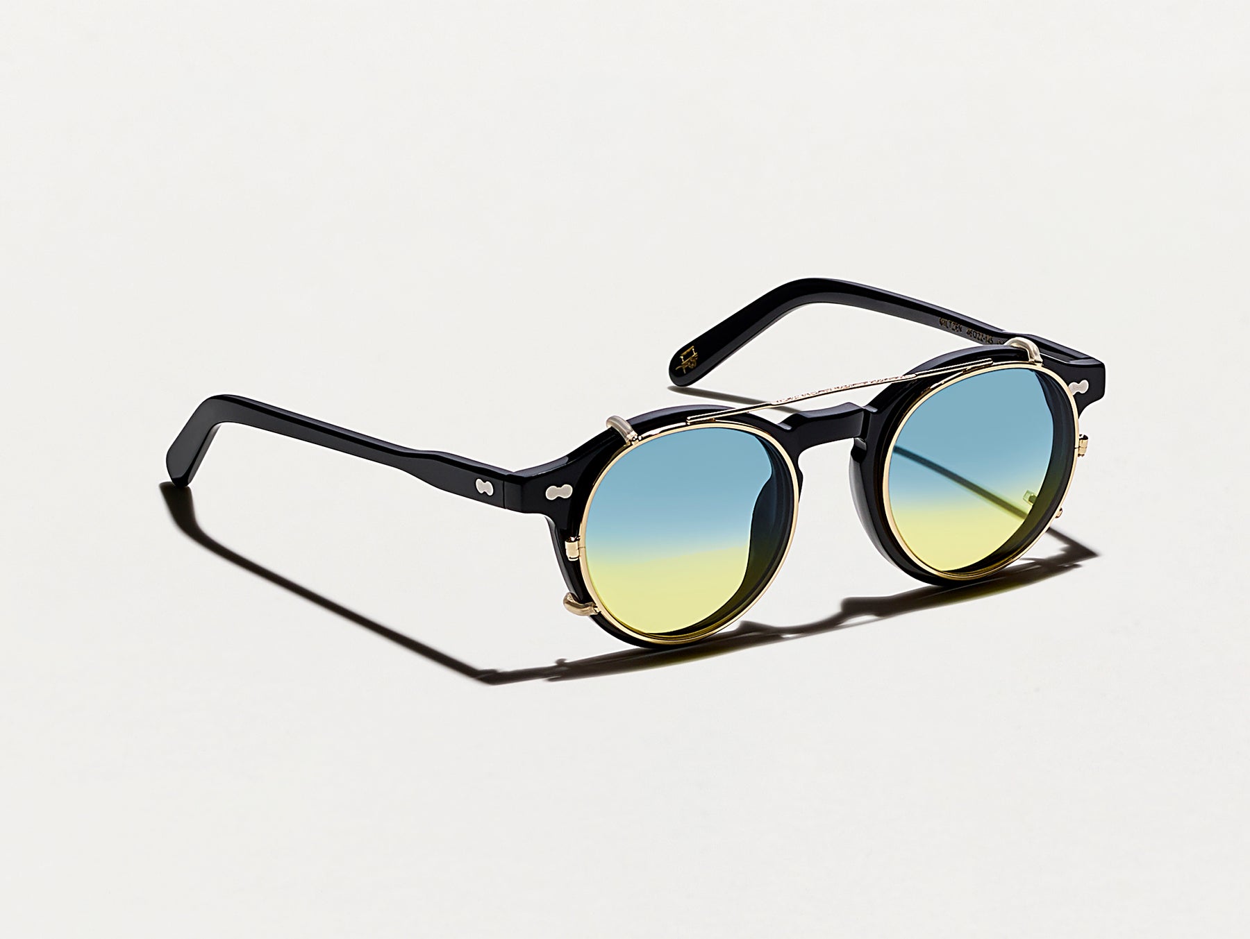 The CLIPZEN in Gold with Aqua Sunrise Tinted Lenses