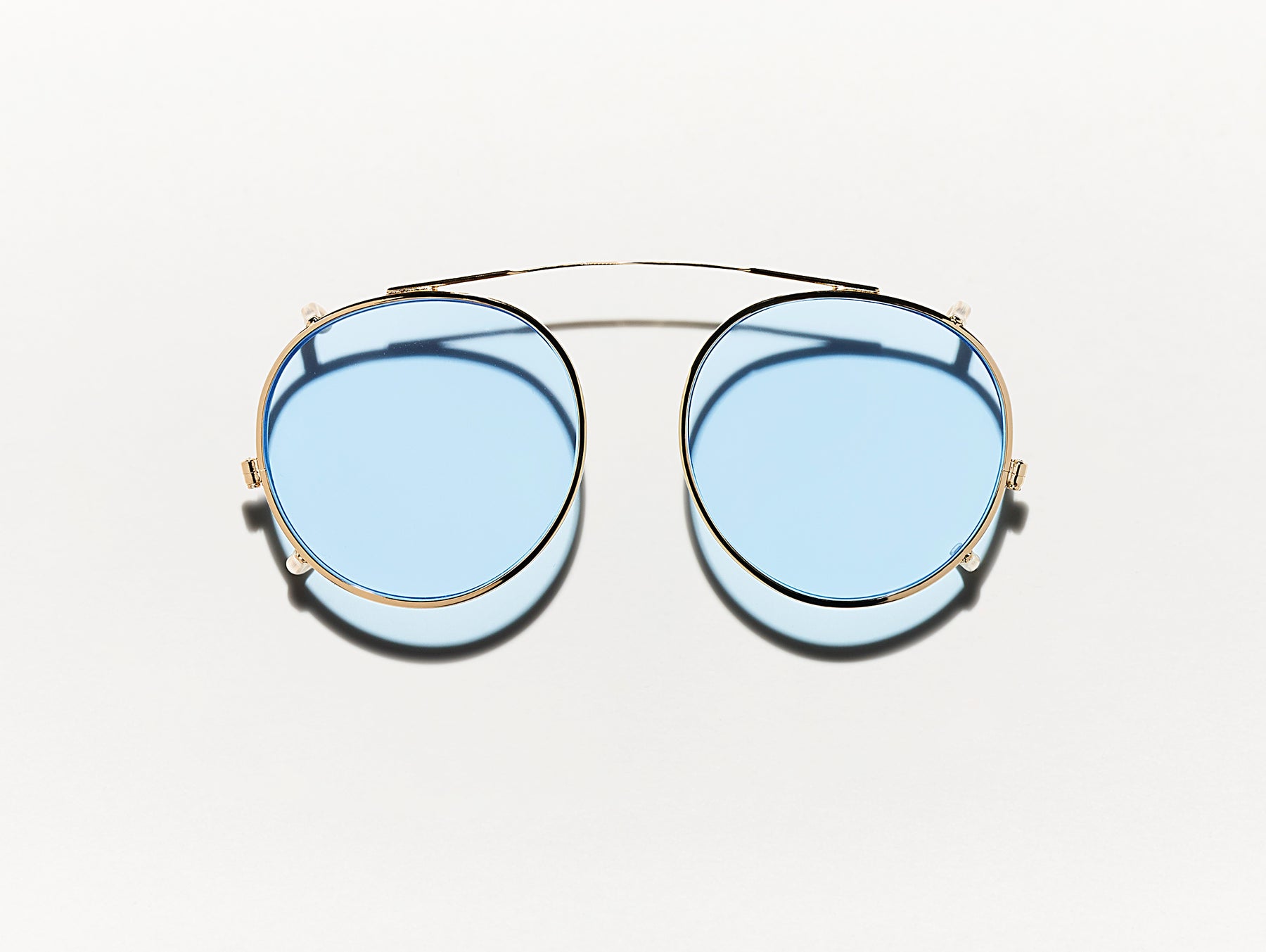 The CLIPZEN in Gold with Bel Air Blue Tinted Lenses