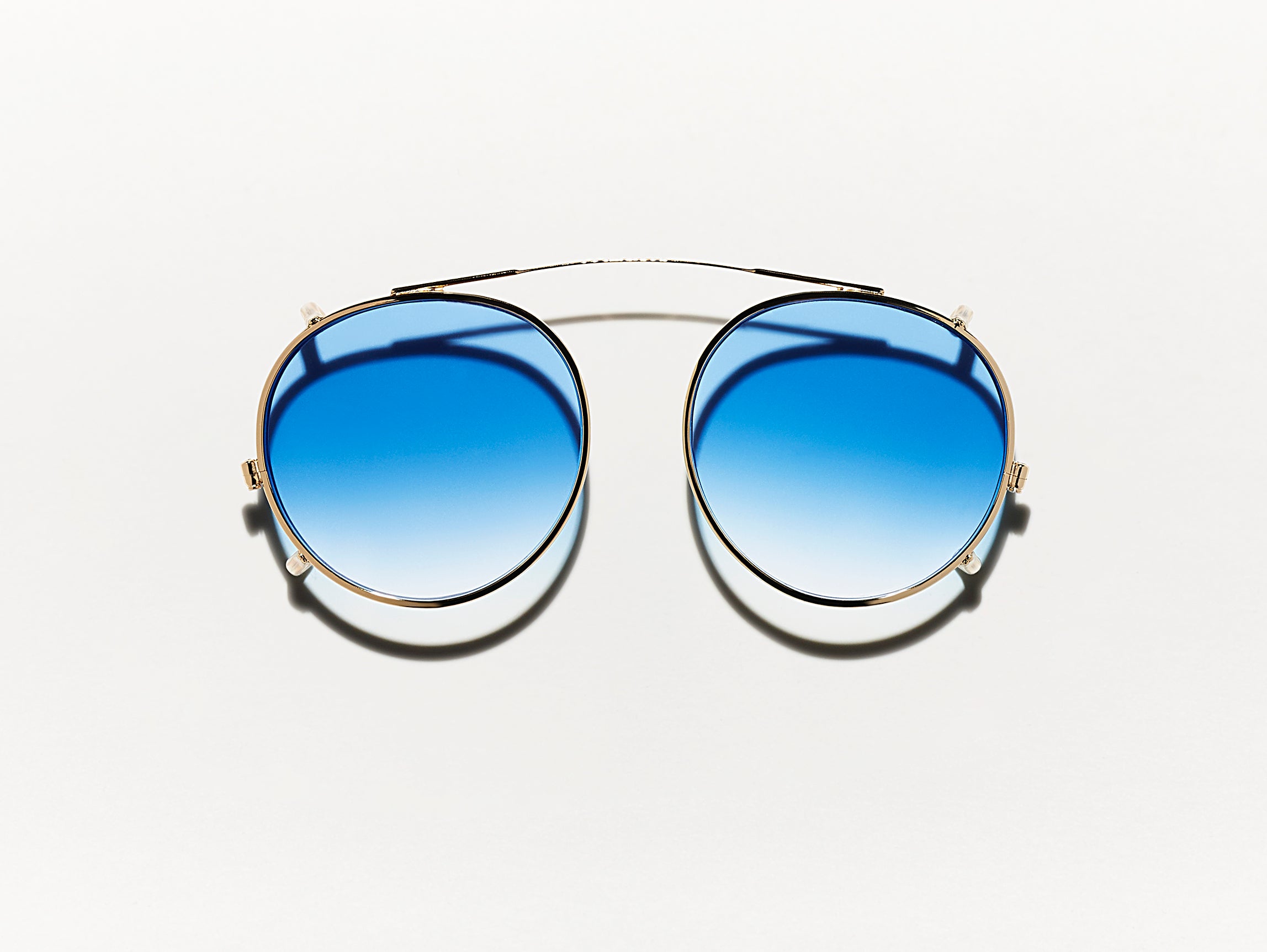 The CLIPZEN in Gold with Broadway Blue Fade Tinted Lenses