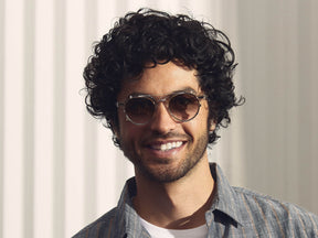 Model is wearing The CLIPZEN in Gold in size 49 with G-15 Fade Tinted Lenses