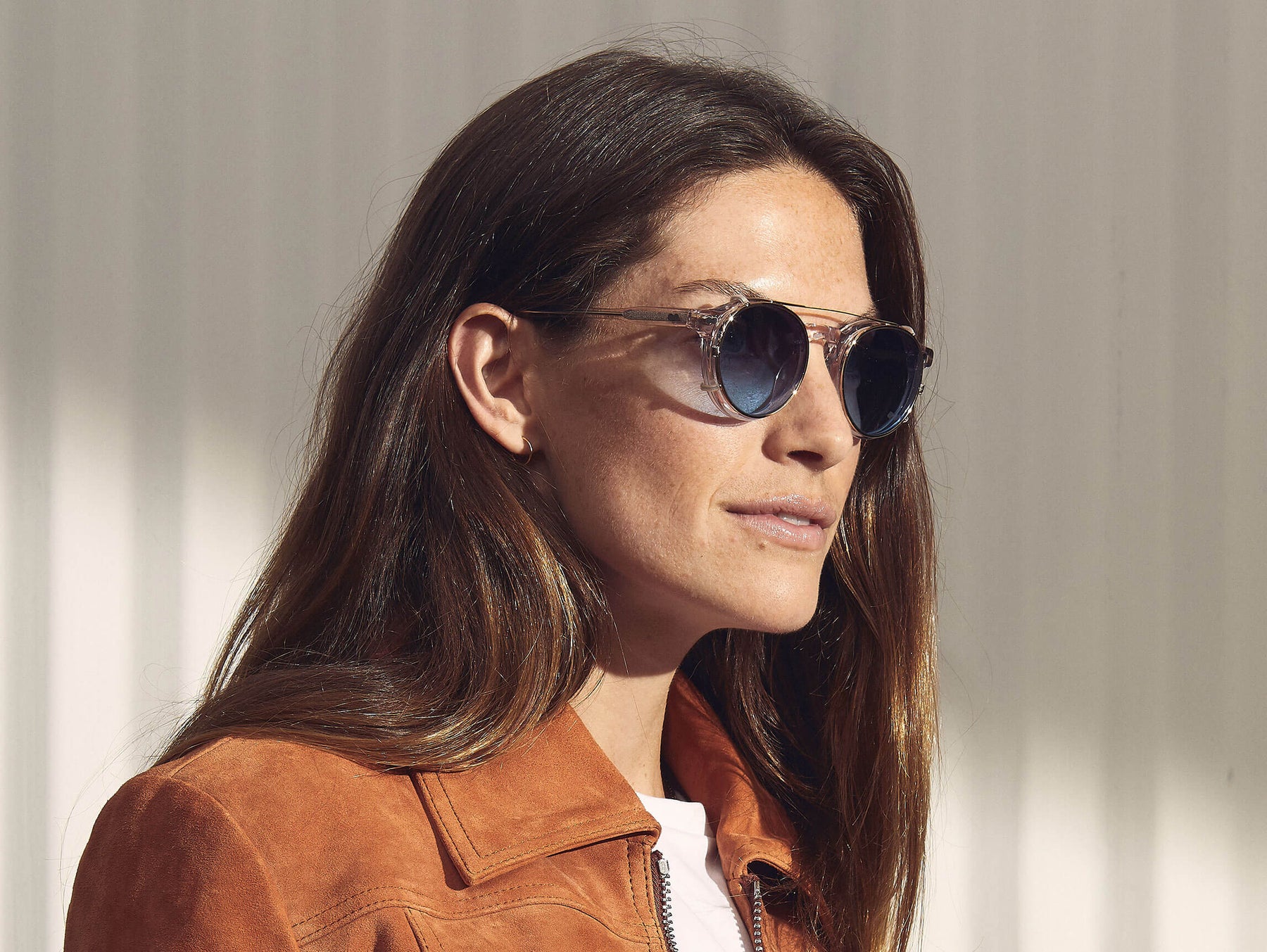 Model is wearing The CLIPZEN in Gold in size 46 with Denim Blue Tinted Lenses