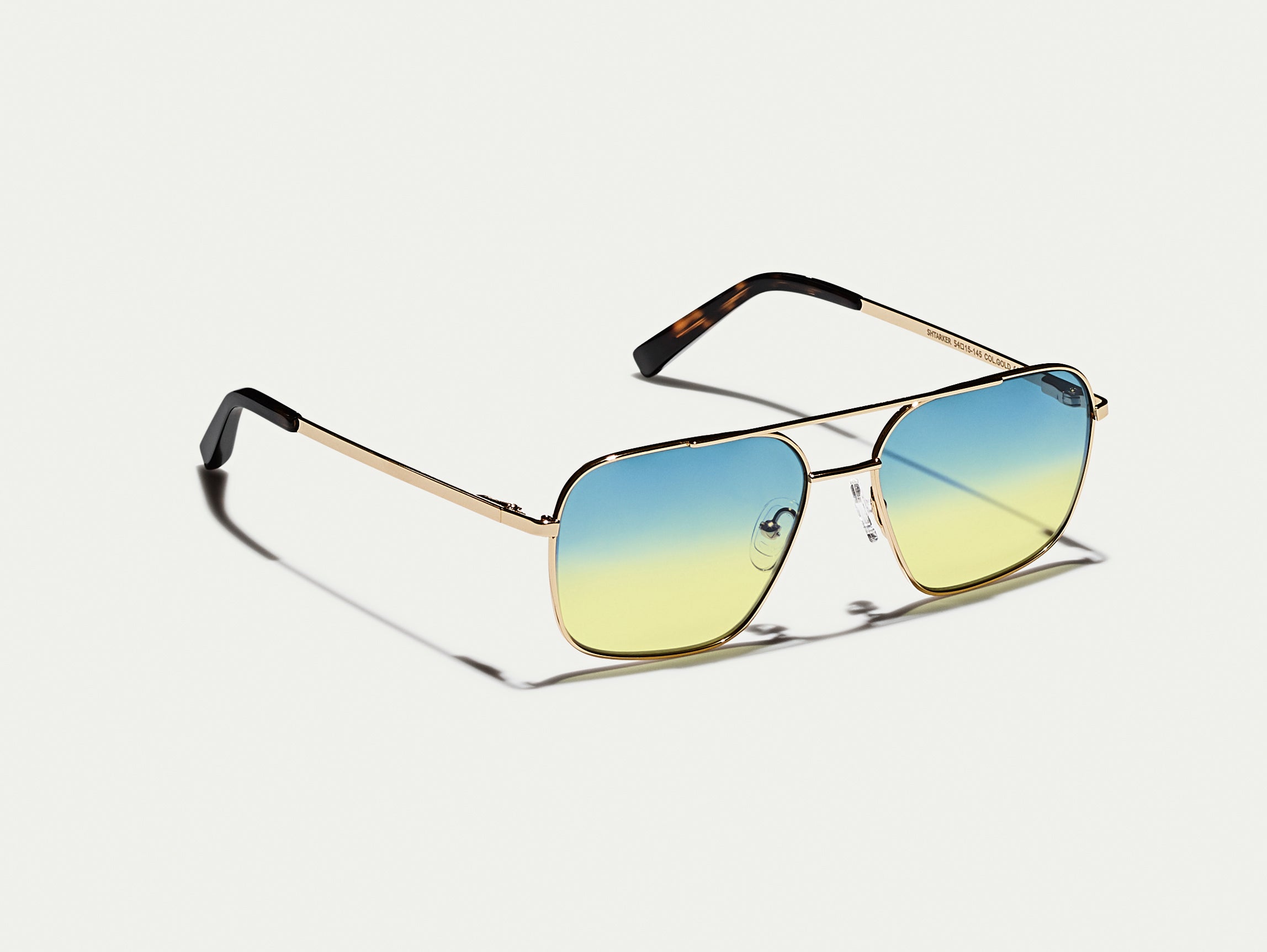 The SHTARKER in Gold with Aqua Sunrise Tinted Lenses