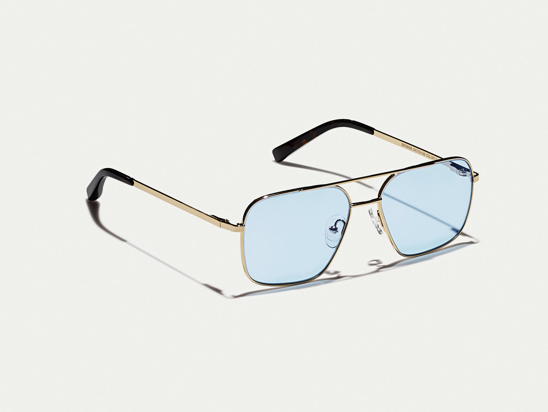 The SHTARKER in Gold with Bel Air Blue Tinted Lenses