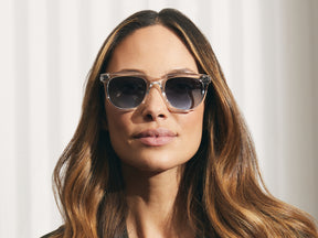 Model is wearing The YONTIF SUN in Crystal in size 52 with Denim Blue Tinted Lenses