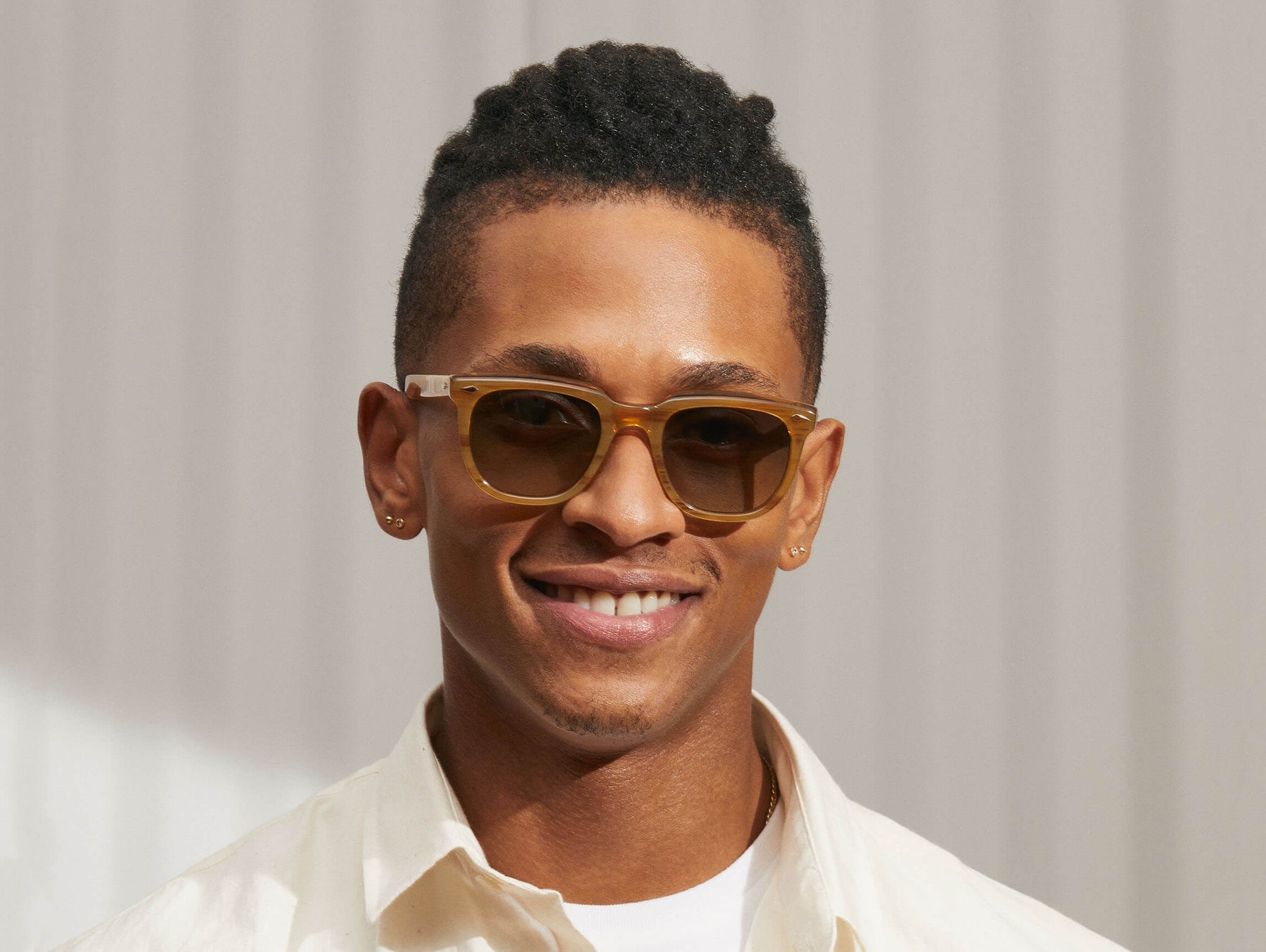 Model is wearing The YONTIF SUN in Blonde in size 49 with Forest Green Tinted Lenses