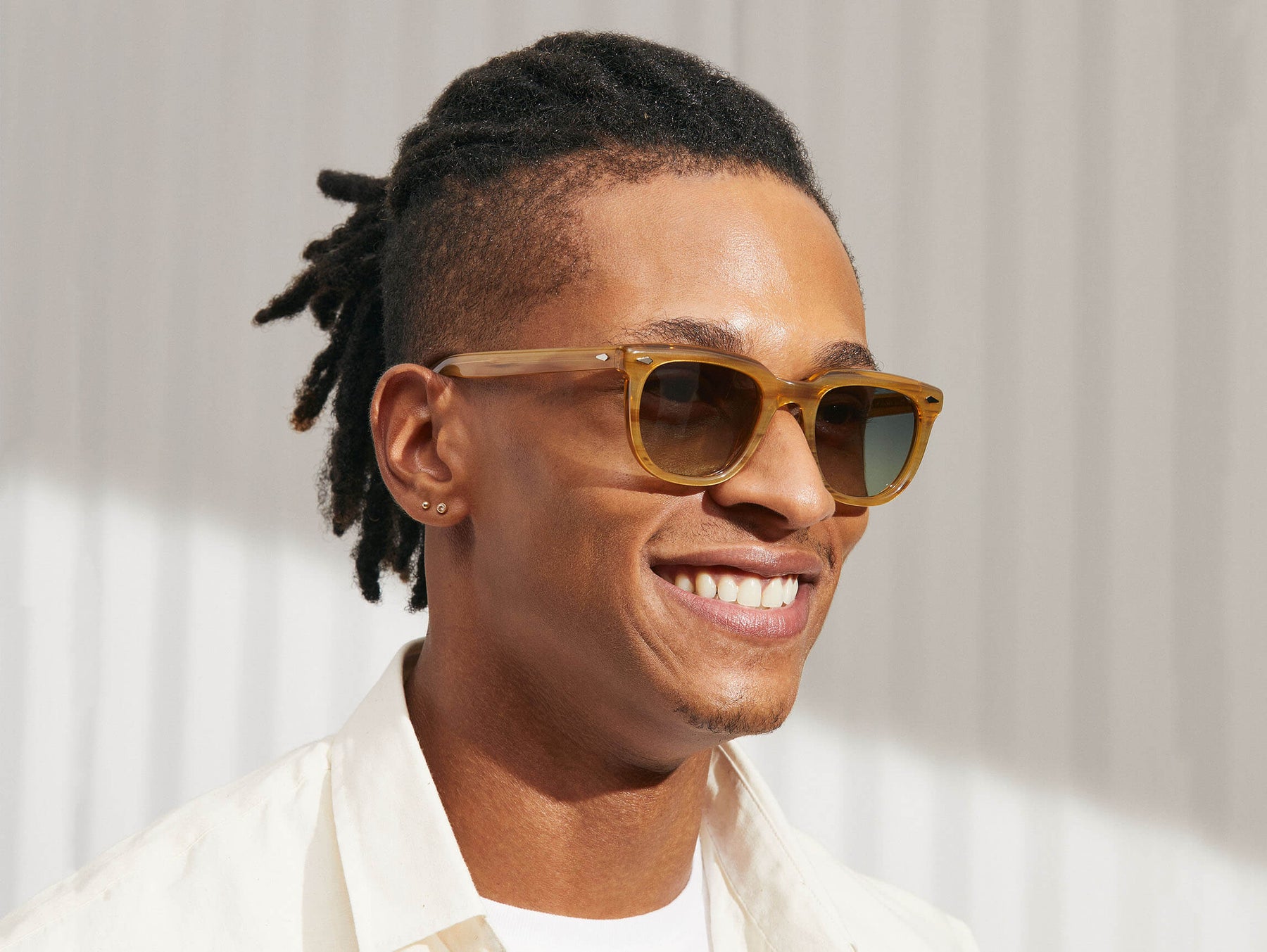 Model is wearing The YONTIF SUN in Blonde in size 49 with Forest Green Tinted Lenses