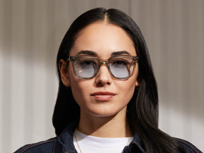 Model is wearing The YONTIF in Sage in size 49 with Bel Air Blue Tinted Lenses