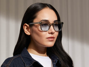 Model is wearing The YONTIF in Sage in size 49 with Bel Air Blue Tinted Lenses