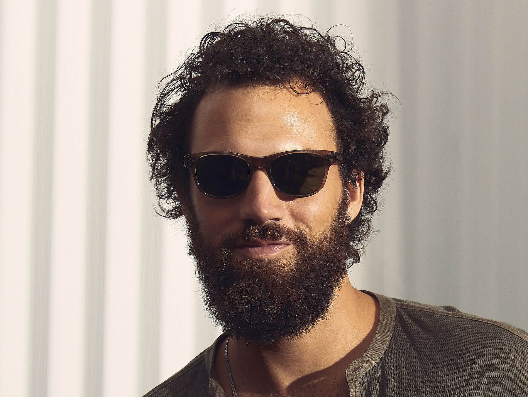 Model is wearing The ZETZ SUN in Brown Ash in size 51 with G-15 Glass Lenses