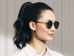 Model is wearing The ZEV SUN in Blonde/Gold in size 49 with G-15 Glass Lenses