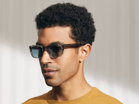 Model is wearing The ZINDIK SUN in Brown Smoke in size 51 with Blue Glass Lenses