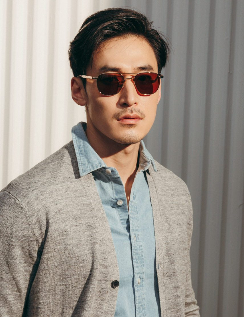 Model is wearing The ZULU SUN in Gold in size 53 with Cosmitan Brown Glass Lenses